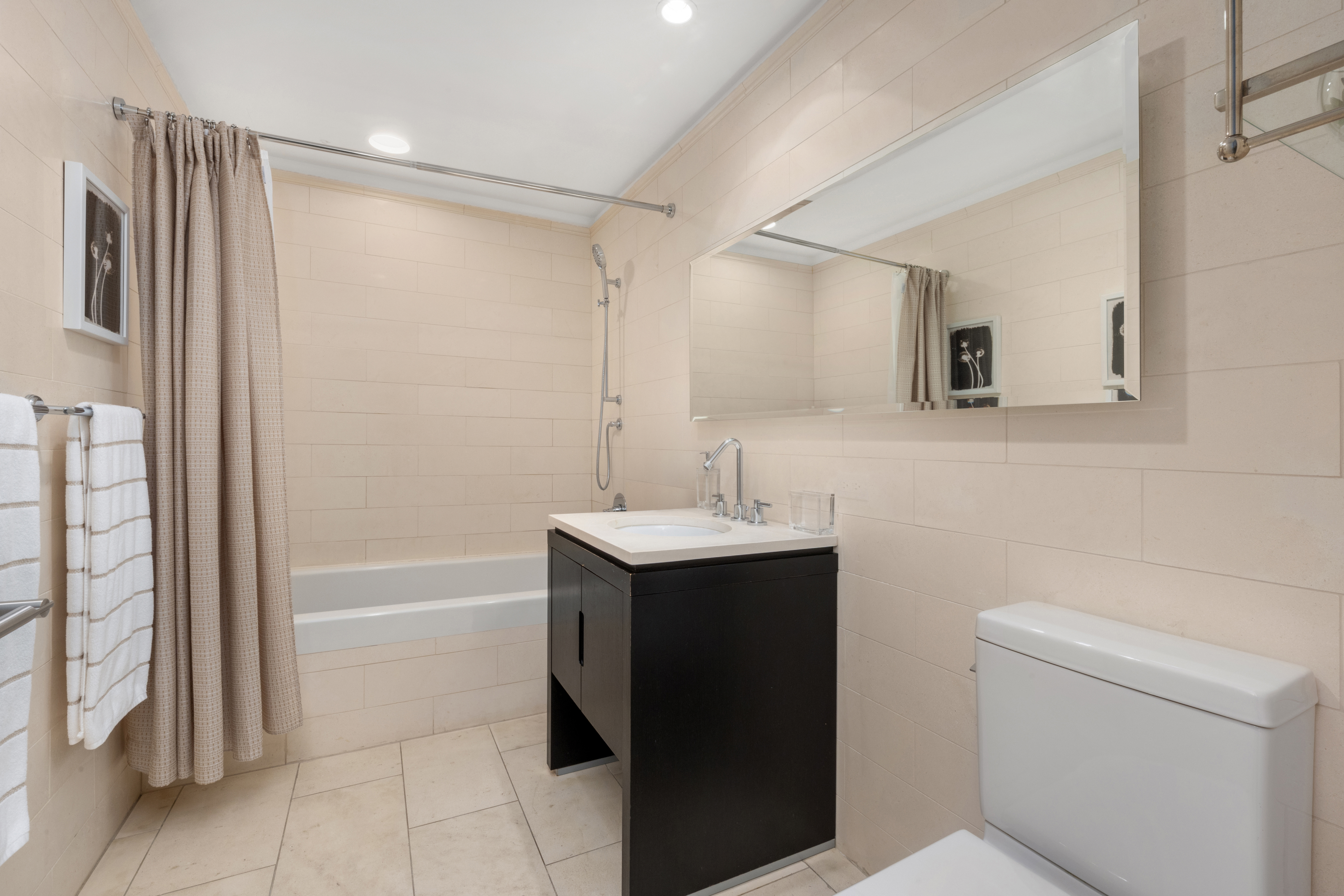 225 5th Avenue, Unit 11A Manhattan, NY 10010 - Photo 8 of 13 a bathroom with a sink toilet and shower