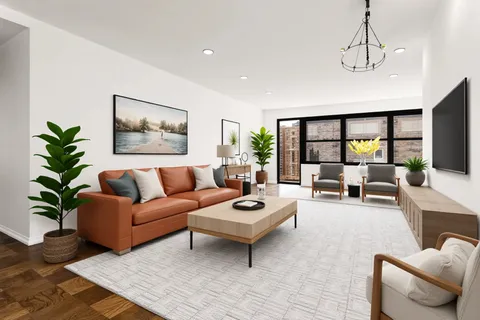 a living room with furniture a chandelier and a flat screen tv