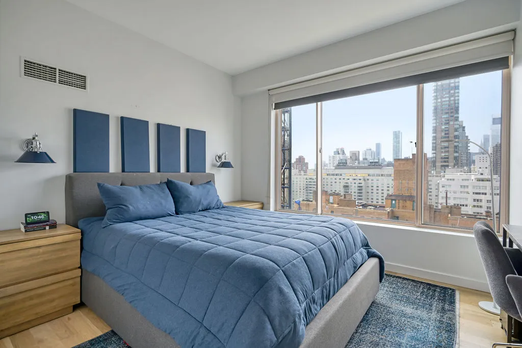 a bedroom with a large bed and a large window