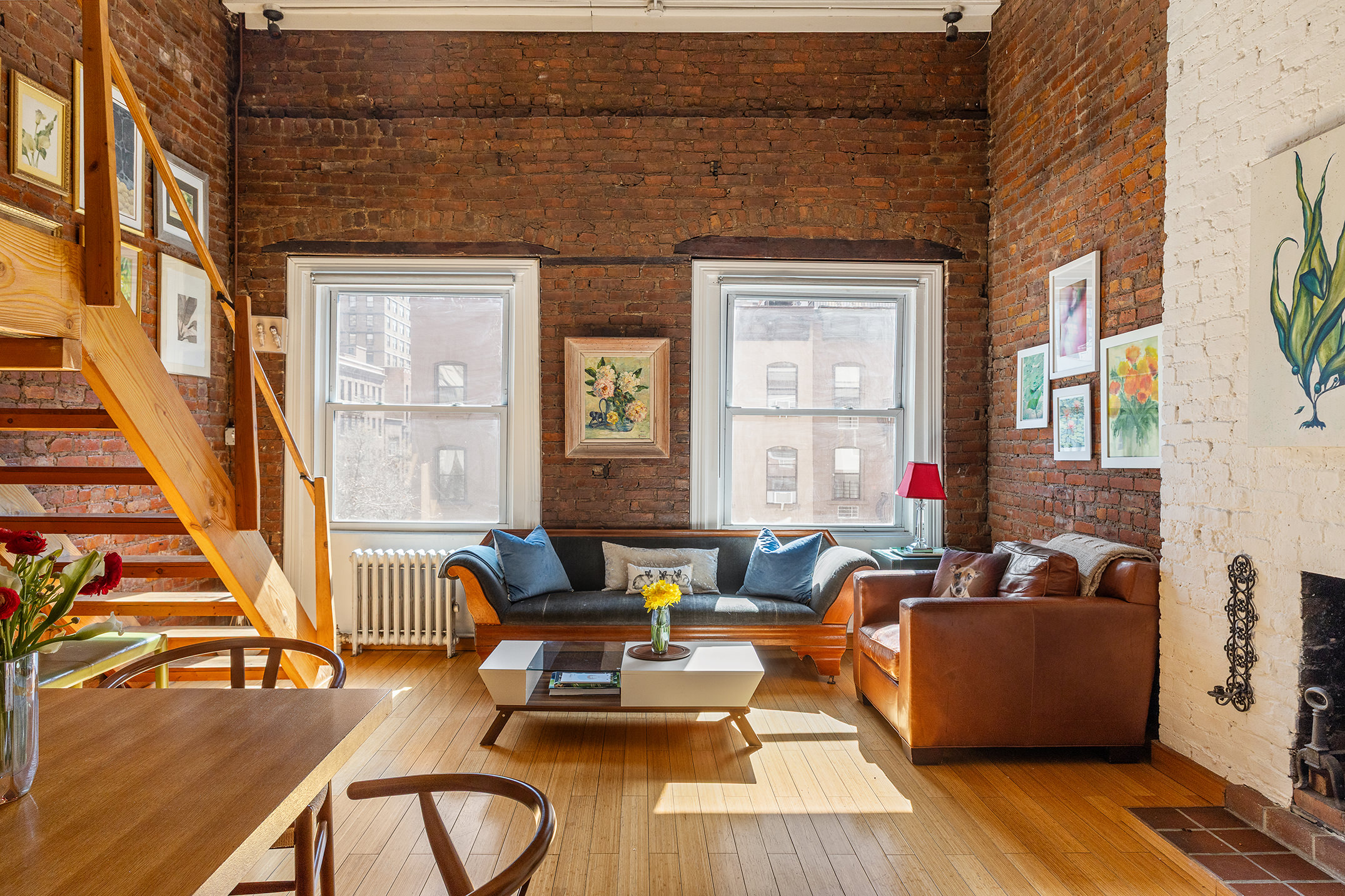 138 Lexington Avenue, Unit PH Manhattan, NY 10016 - Photo 2 of 15 a living room with furniture and a fireplace