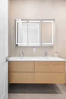 a bathroom with a sink vanity and mirror