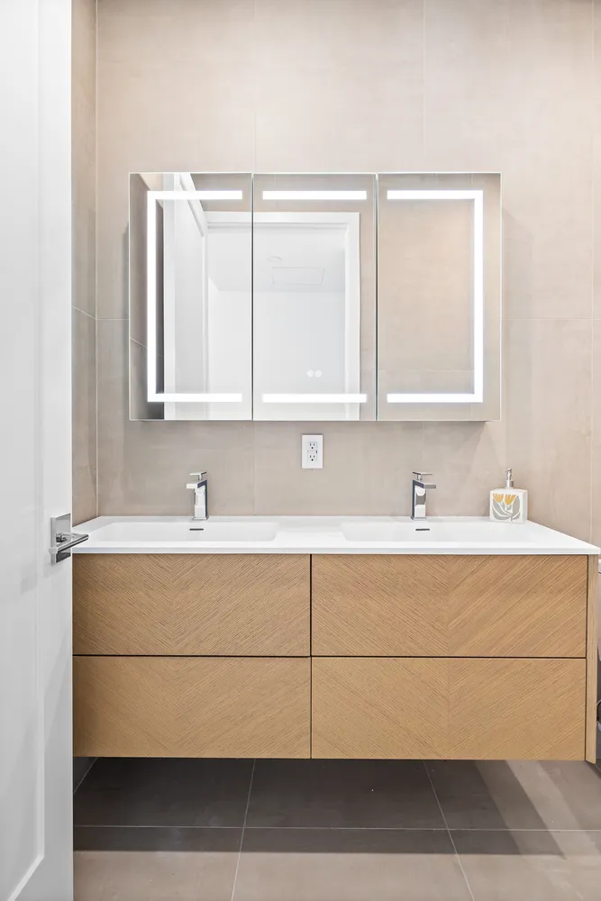 a bathroom with a sink vanity and mirror