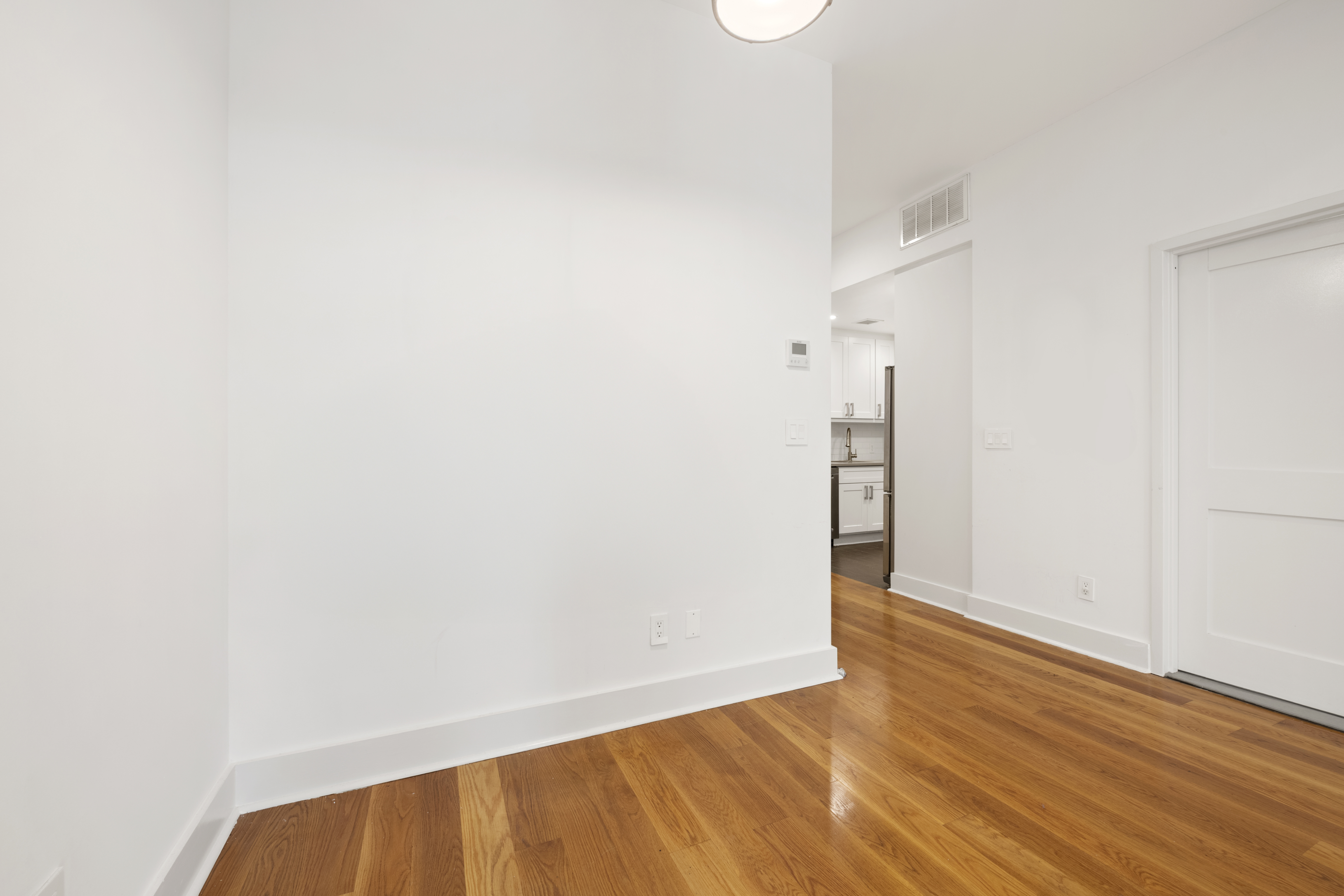 25 Lexington Avenue, Unit 103 Brooklyn, NY 11238 - Photo 5 of 15 a view of an empty room with wooden floor and a window
