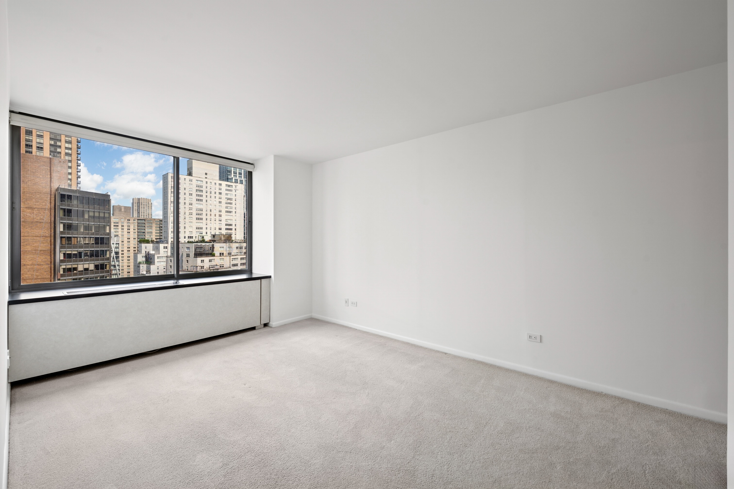 111 West 67th Street, Unit 22B Manhattan, NY 10023 - Photo 4 of 10 an empty room with large windows