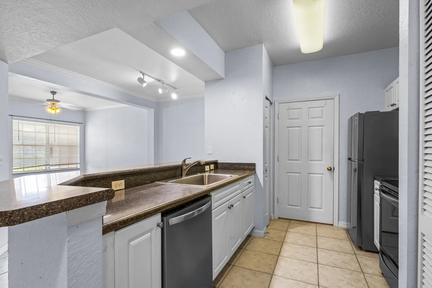 a kitchen with a sink and a stove top oven