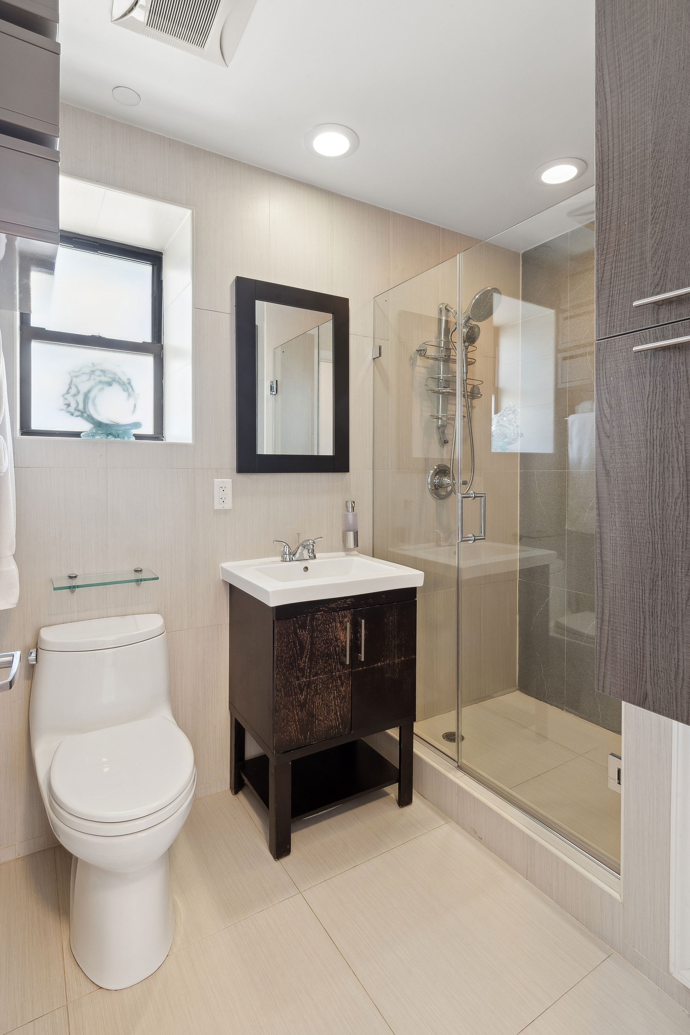 456 West 167th Street, Unit 7C Manhattan, NY 10032 - Photo 11 of 16 a bathroom with a sink a toilet and shower