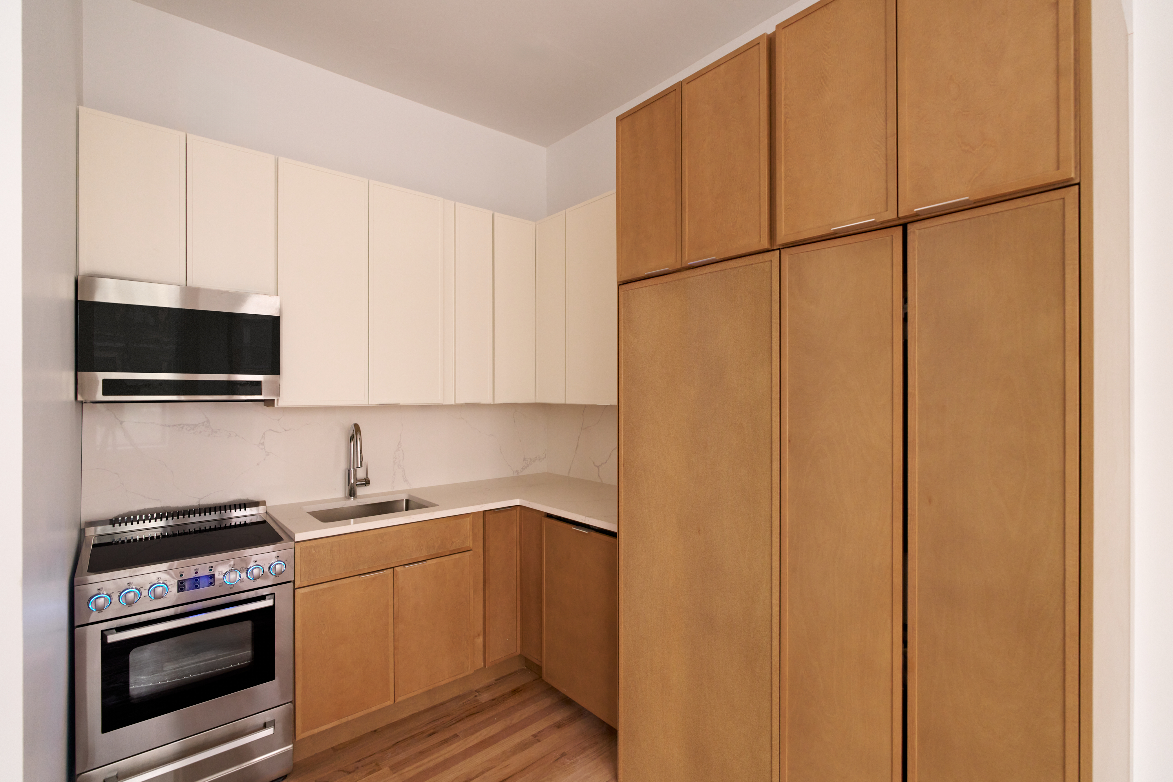 310 West 80th Street, Unit 2D Manhattan, NY 10024 - Photo 2 of 6 a kitchen with a sink a stove and cabinets
