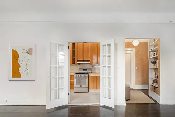 26 East 63rd Street, Unit 5F Manhattan, NY 10065 - Photo 4 of 5 a kitchen with stainless steel appliances granite countertop a refrigerator and a stove top oven