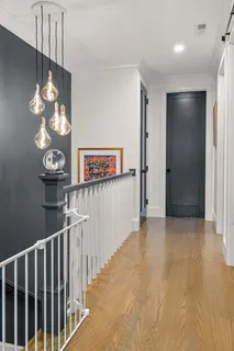a view of a hallway with chandelier