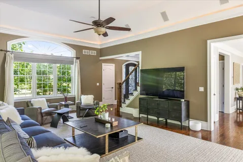 a dining room with furniture a potted plant and wooden floor