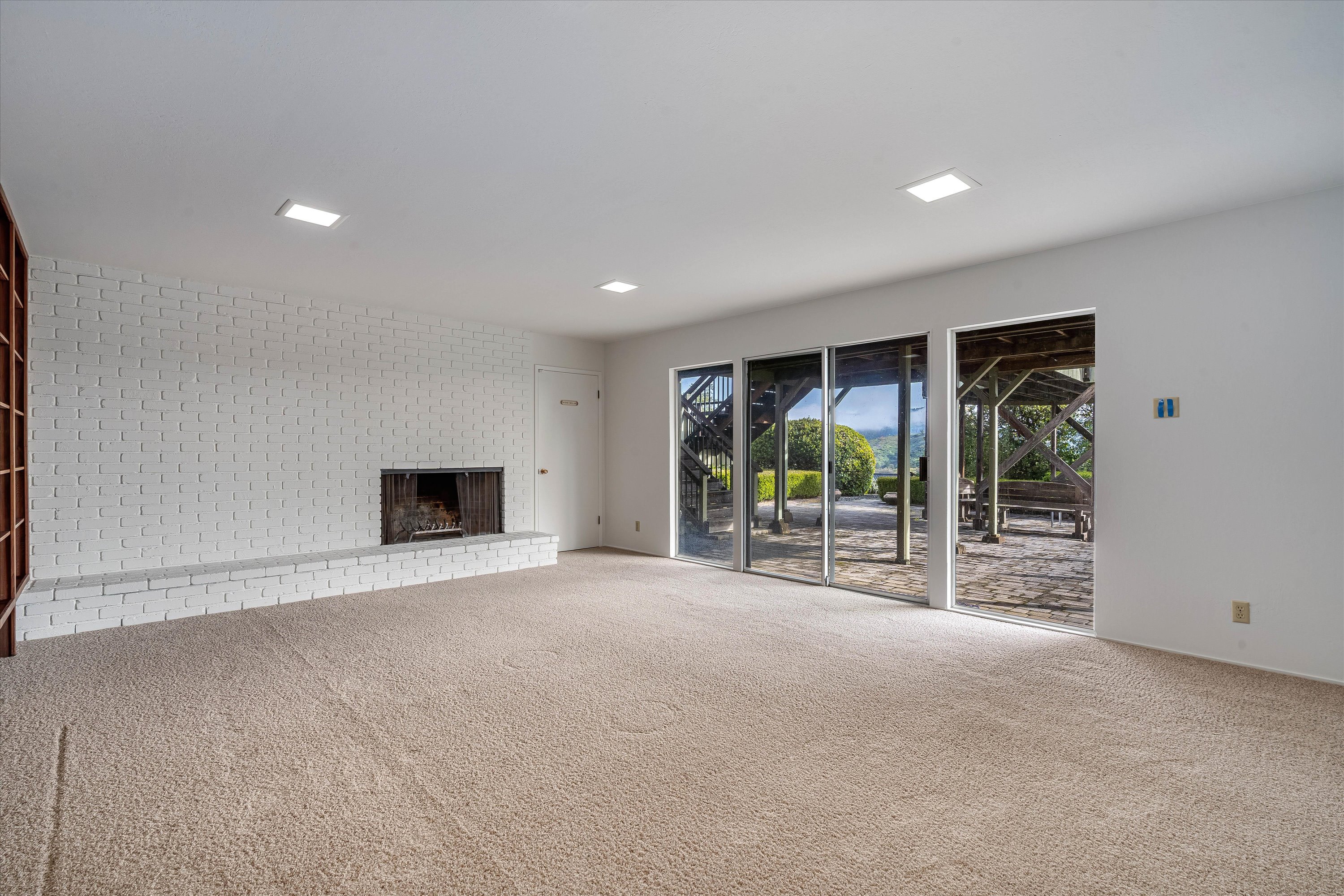 1291 Rockland Drive St. Helena, CA 94574 - Photo 16 of 26 a view of an empty room with a fireplace and a large window