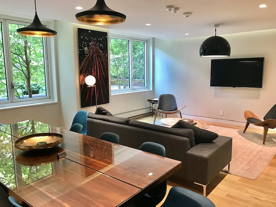 301 West 53rd Street, Unit 3I Manhattan, NY 10019 - Photo 13 of 14 a living room with furniture and a chandelier