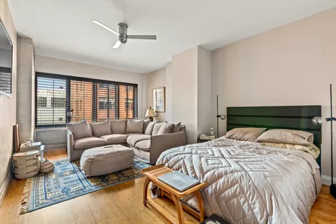 a spacious bedroom with two beds and a large window
