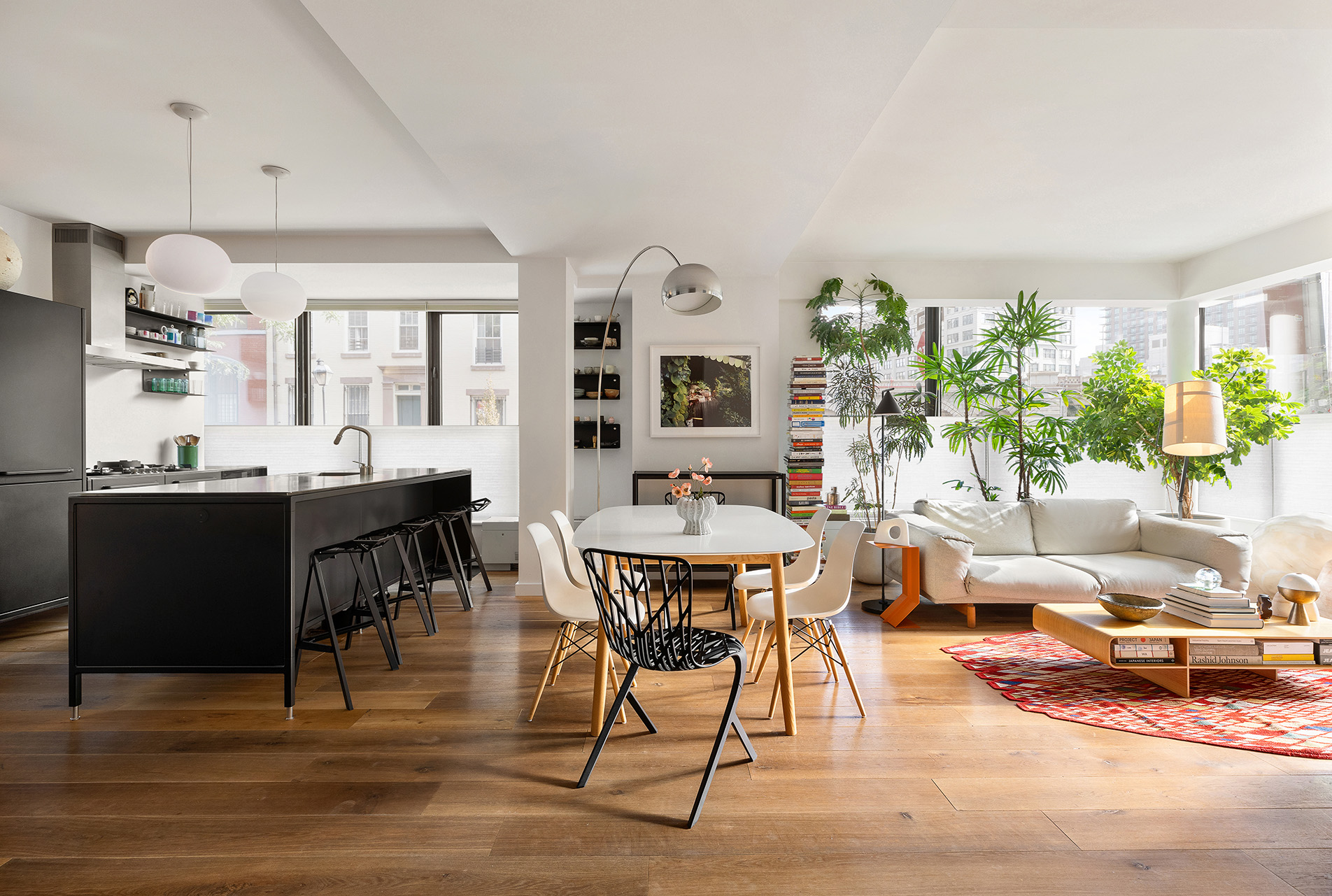 a living room with furniture a dining table and a large window