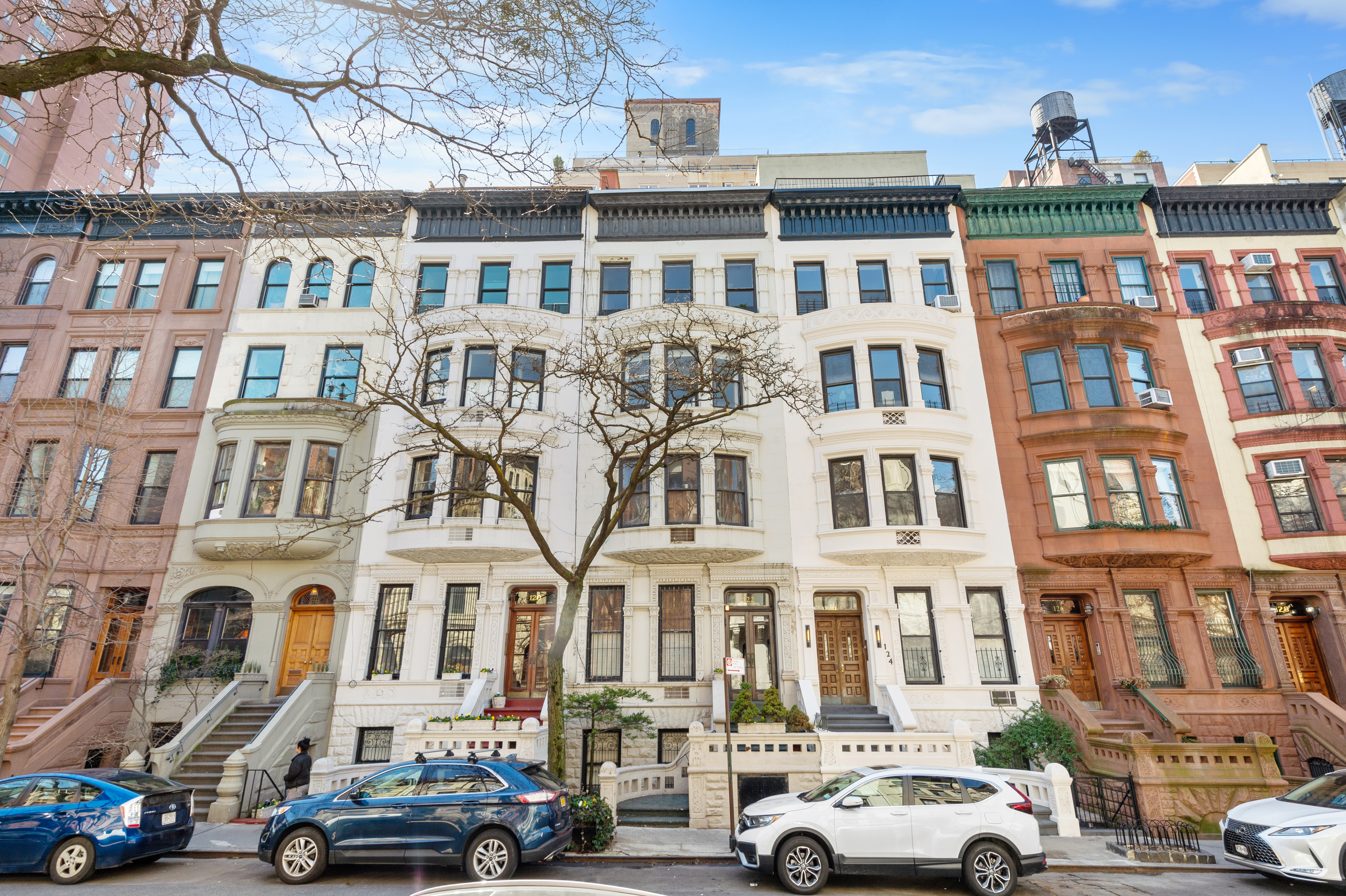 a front view of a residential apartment building with a yard
