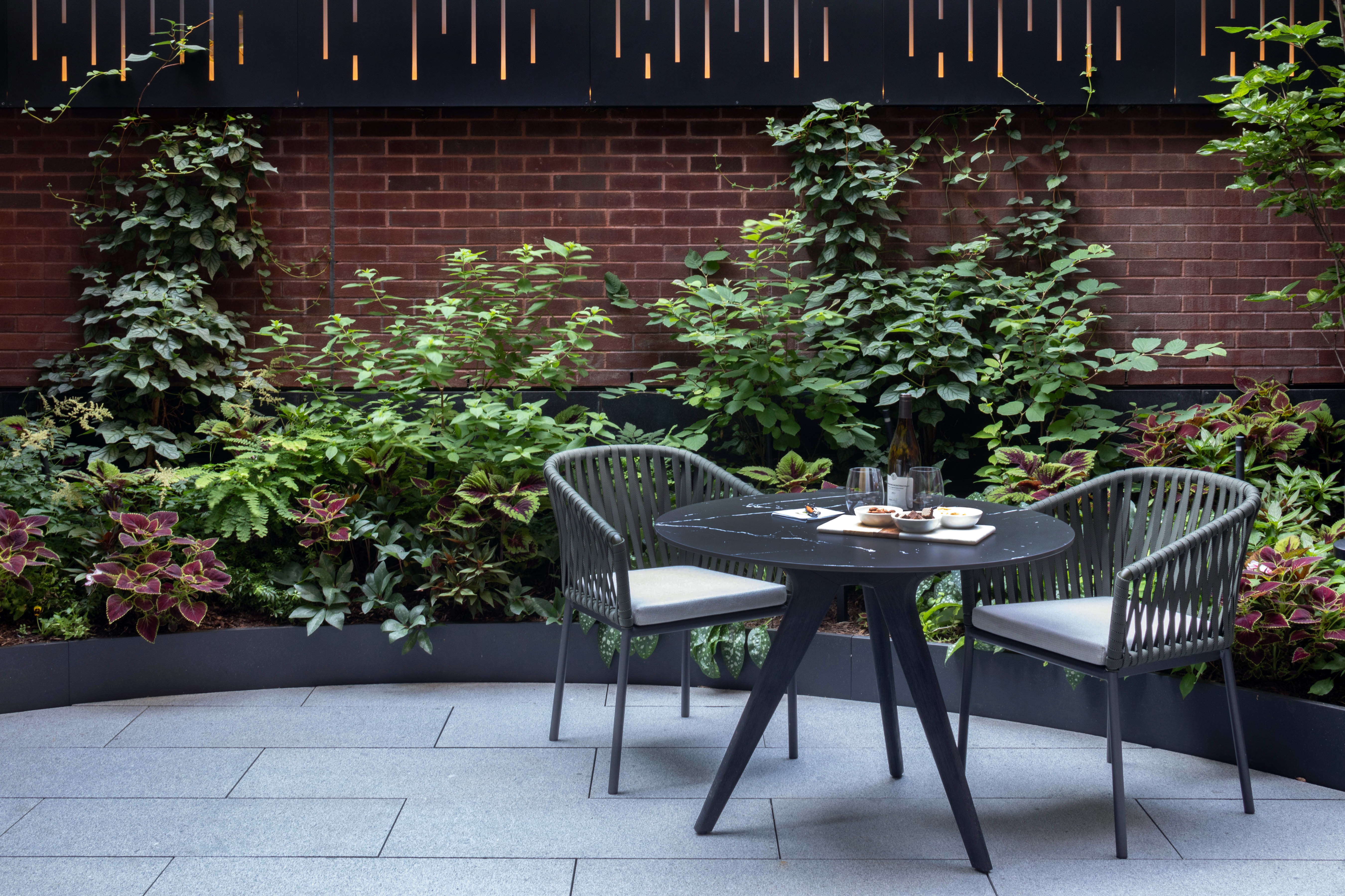 150 Charles Street, Unit M10 Manhattan, NY 10014 - Photo 26 of 34 a view of a chairs and table in a backyard