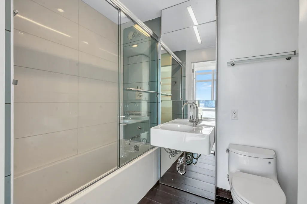 a bathroom with a sink toilet and shower