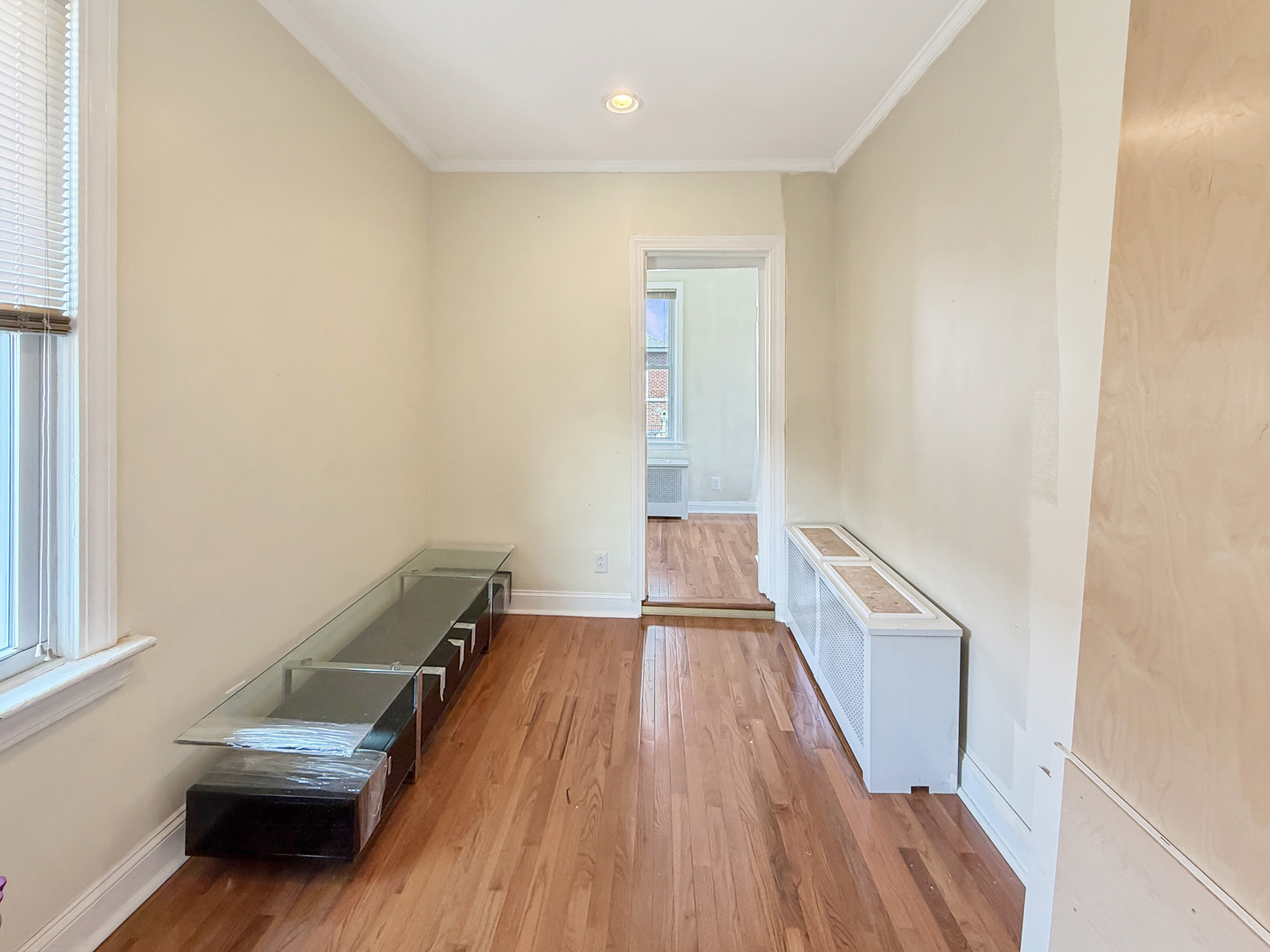 3735 Oceanic Avenue Brooklyn, NY 11224 - Photo 19 of 26 a view of a hallway with wooden floor and staircase