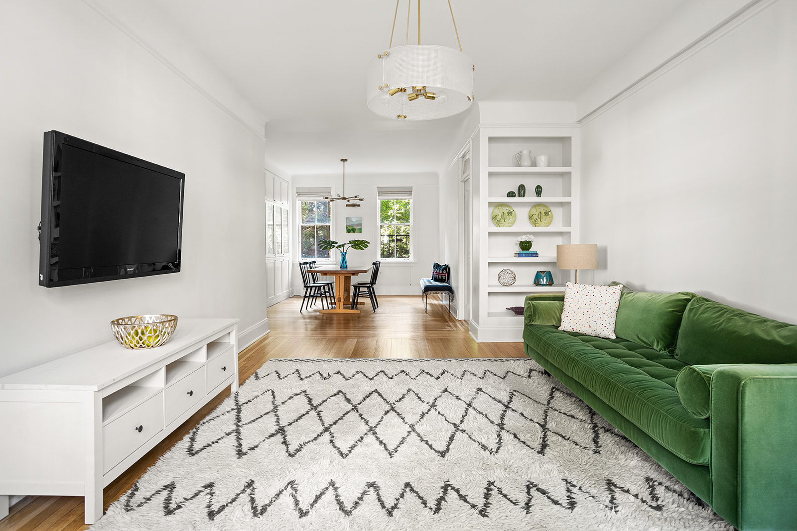 35-16 79th Street, Unit 1 Queens, NY 11372 - Photo 2 of 14 a living room with furniture and a flat screen tv