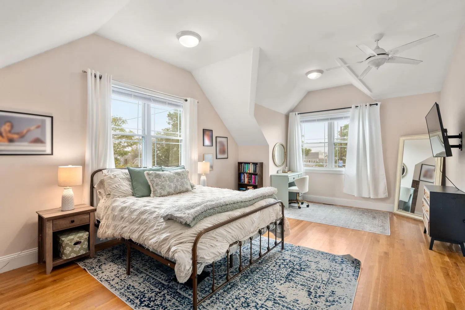 a bedroom with a bed window and a table