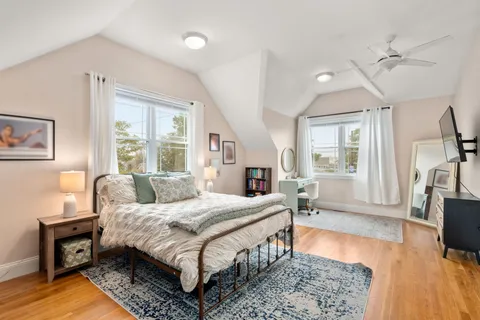 a bedroom with a bed window and a table