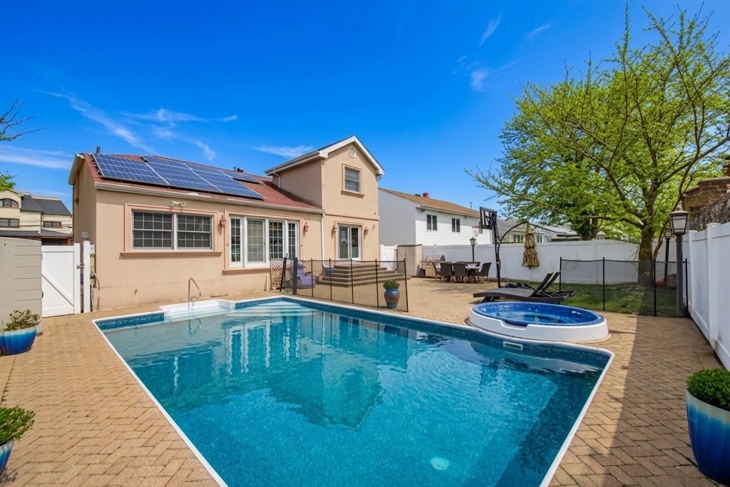 2310 East 66th Street Brooklyn, NY 11234 - Photo 3 of 24 a view of a house with pool and sitting area