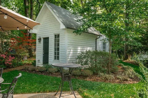 a view of house with a yard