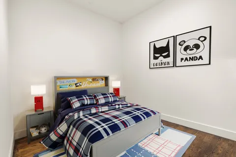 a bedroom with a bed and painting on the wall
