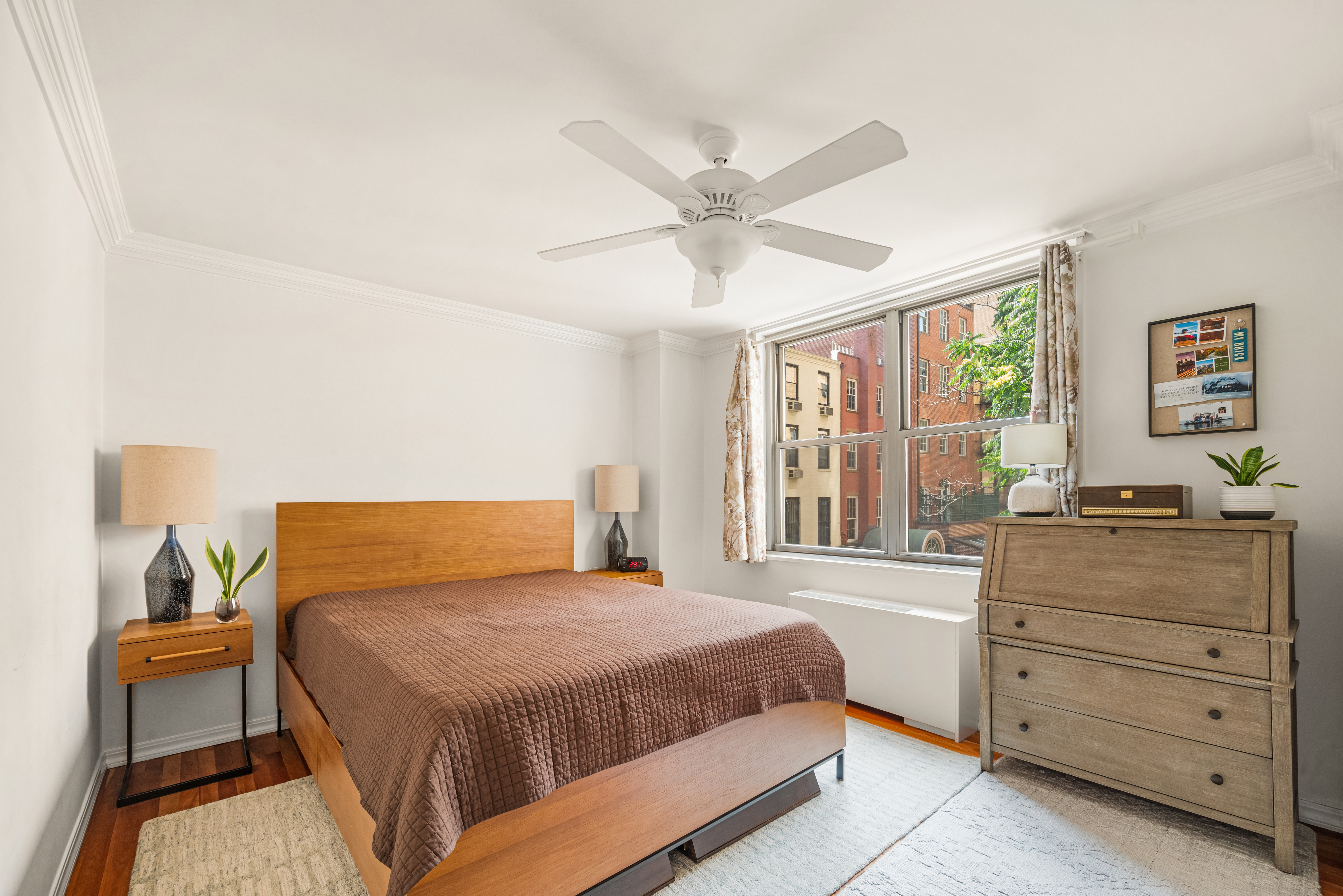 444 East 86th Street, Unit 4D Manhattan, NY 10028 - Photo 5 of 12 a bedroom with a large bed and a window