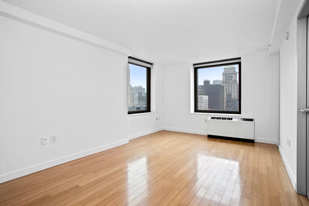 100 West 39th Street, Unit 37E Manhattan, NY 10018 - Photo 2 of 11 a view of a room with wooden floor and a window