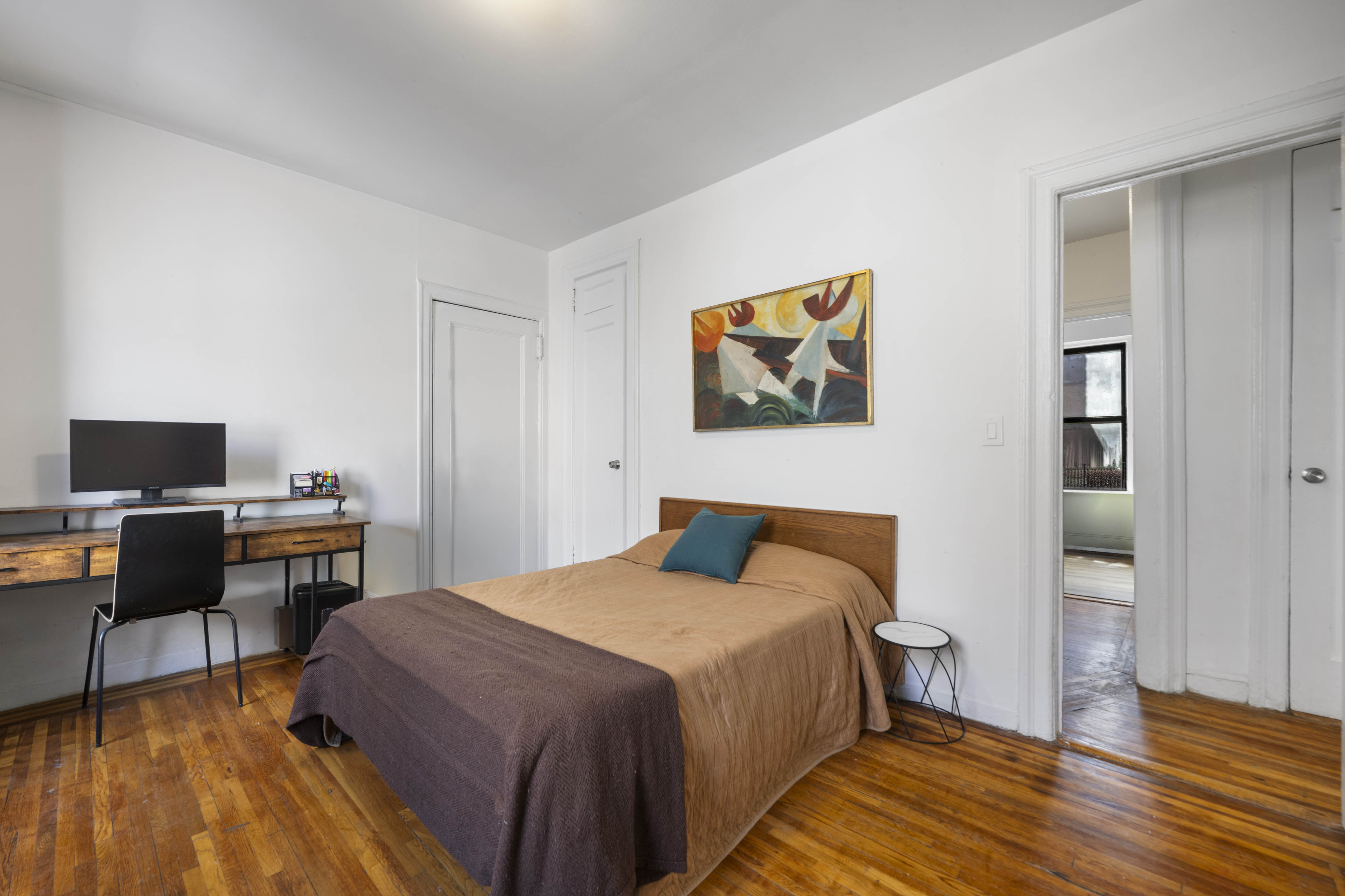 2199 Holland Avenue, Unit 5P Bronx, NY 10462 - Photo 8 of 11 a bedroom with a bed and wooden floor