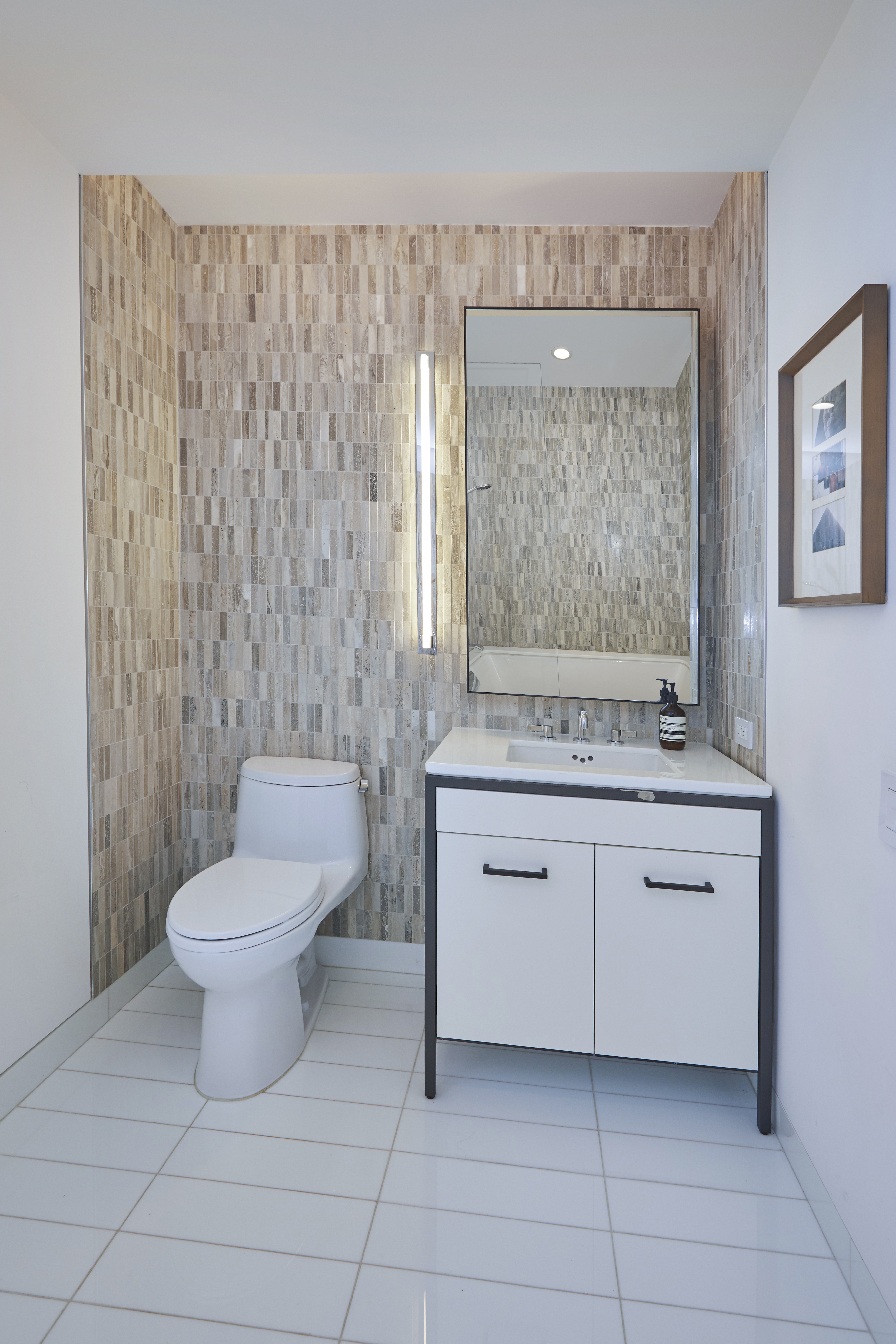 70 Charlton Street, Unit 7E Manhattan, NY 10014 - Photo 8 of 17 a bathroom with a toilet a sink and mirror