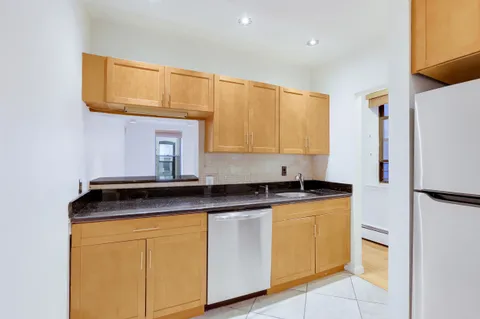a kitchen with stainless steel appliances granite countertop a sink and a cabinets
