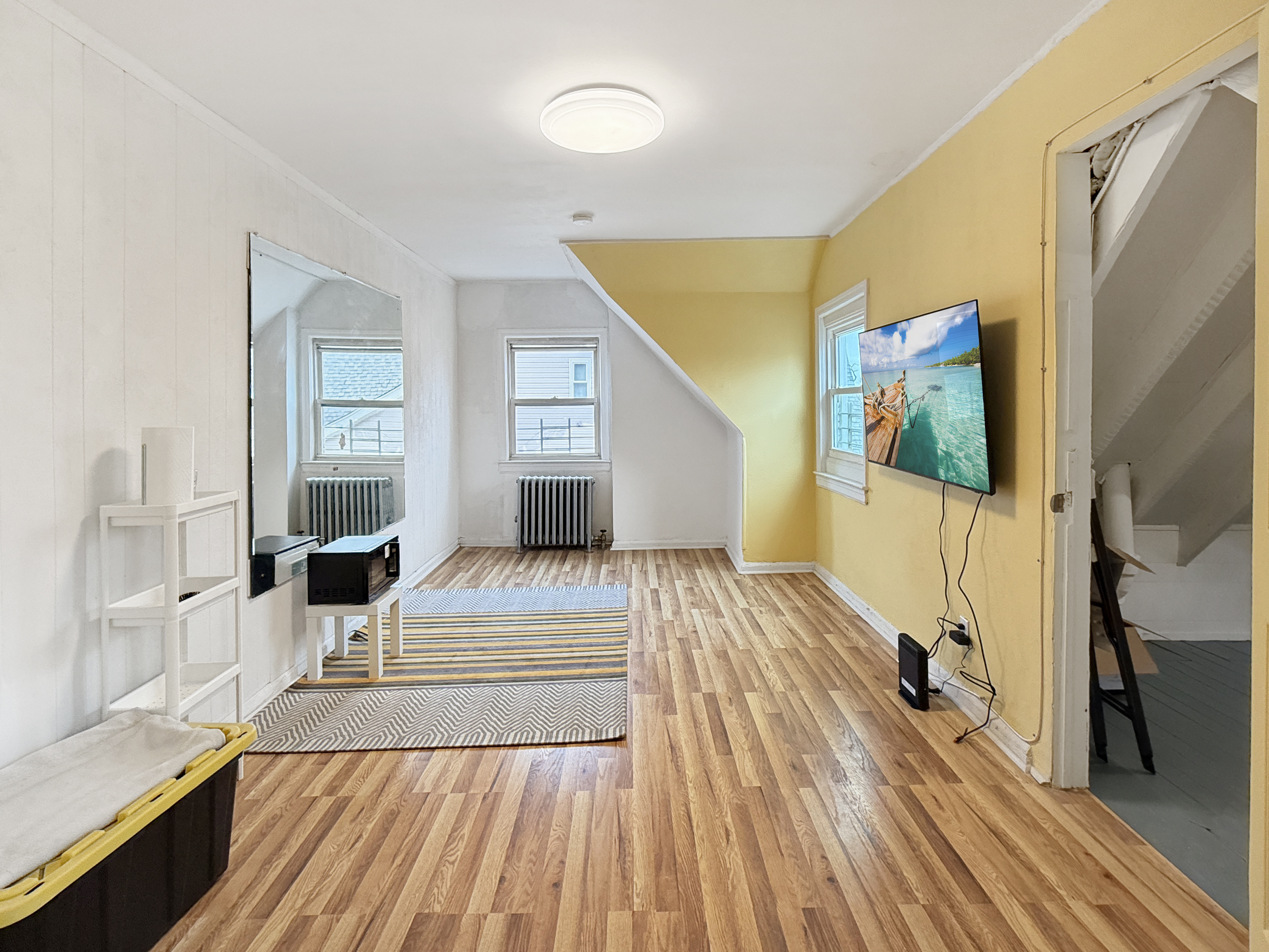 4215 Atlantic Avenue Brooklyn, NY 11224 - Photo 10 of 21 a bedroom with a bed and wooden floor