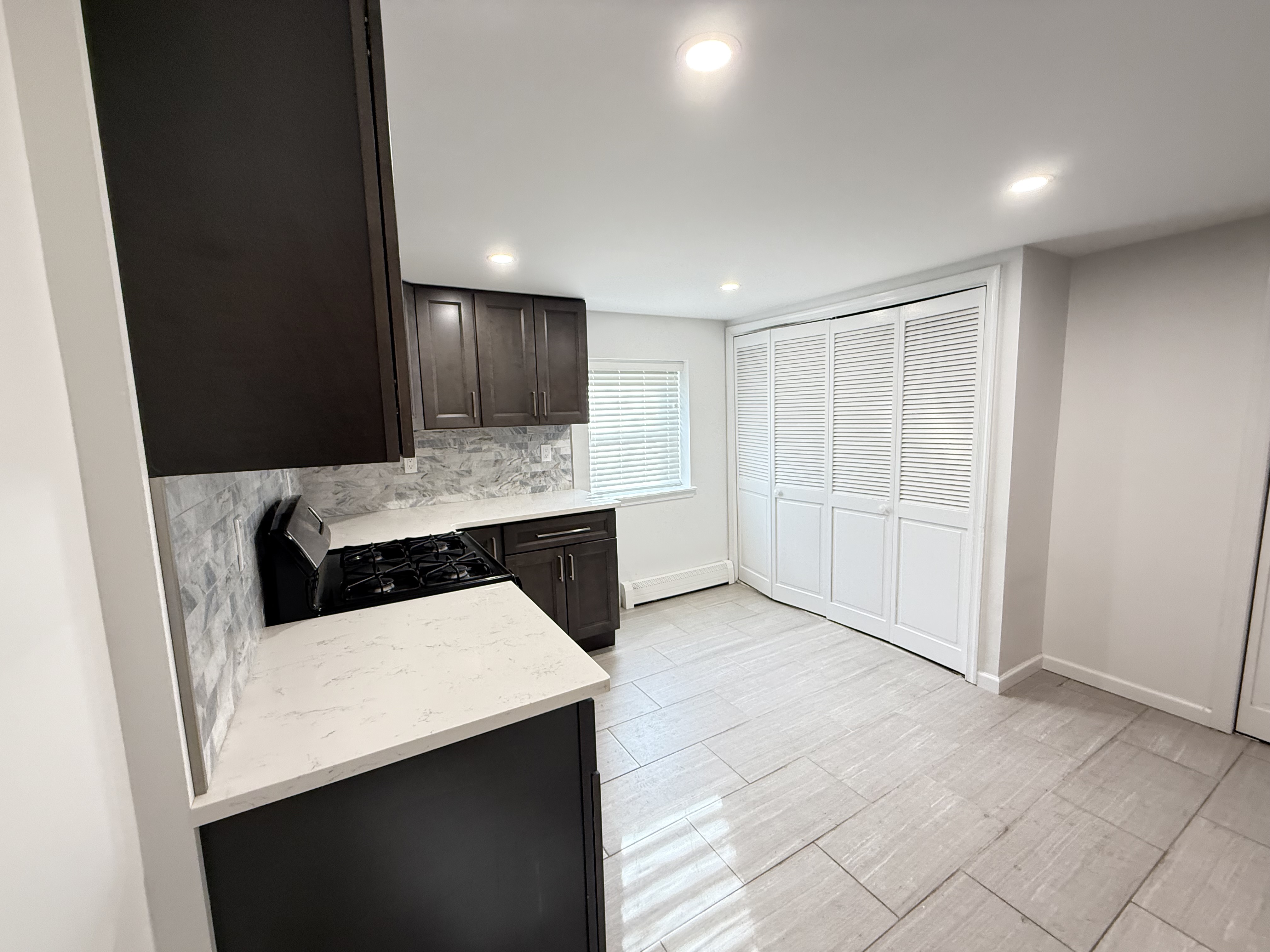 3236 Country Club Road Bronx, NY 10465 - Photo 19 of 22 a kitchen with a sink a stove and cabinets
