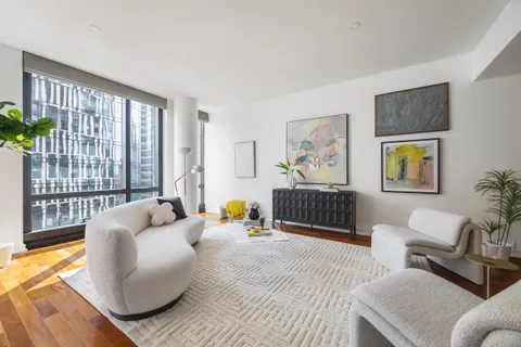 a bedroom with furniture and a large window