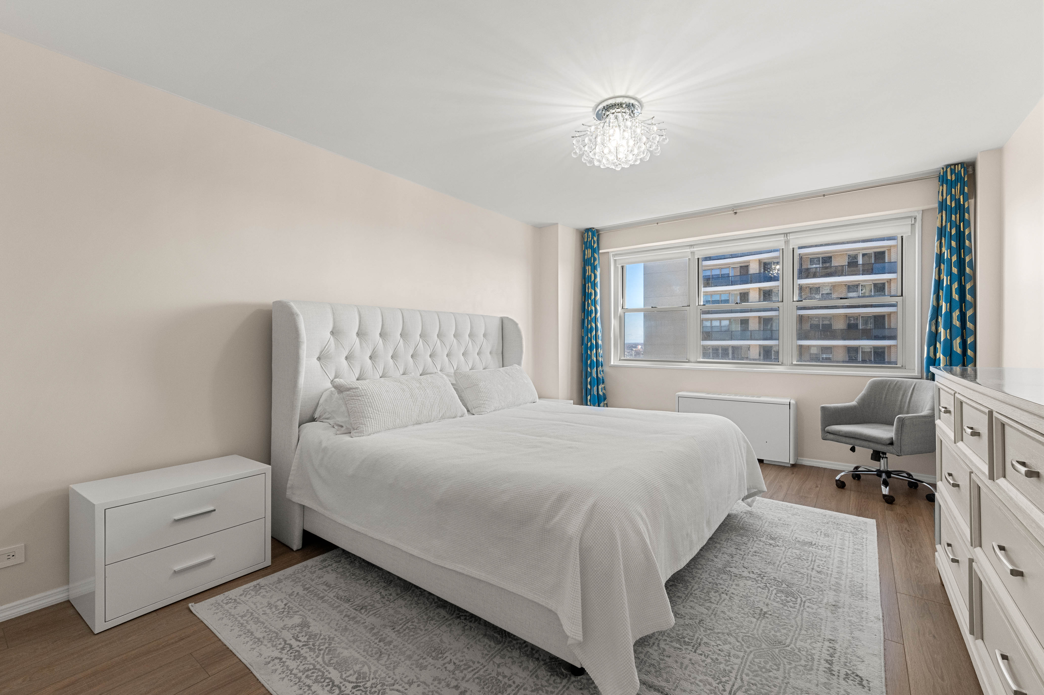 102-10 66th Road, Unit 21K Queens, NY 11375 - Photo 7 of 16 a bedroom with a bed and a large window