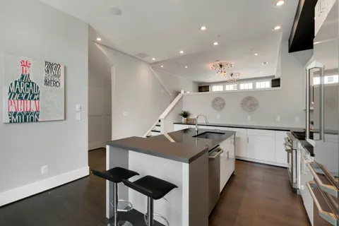a kitchen with a sink stainless steel appliances and cabinets