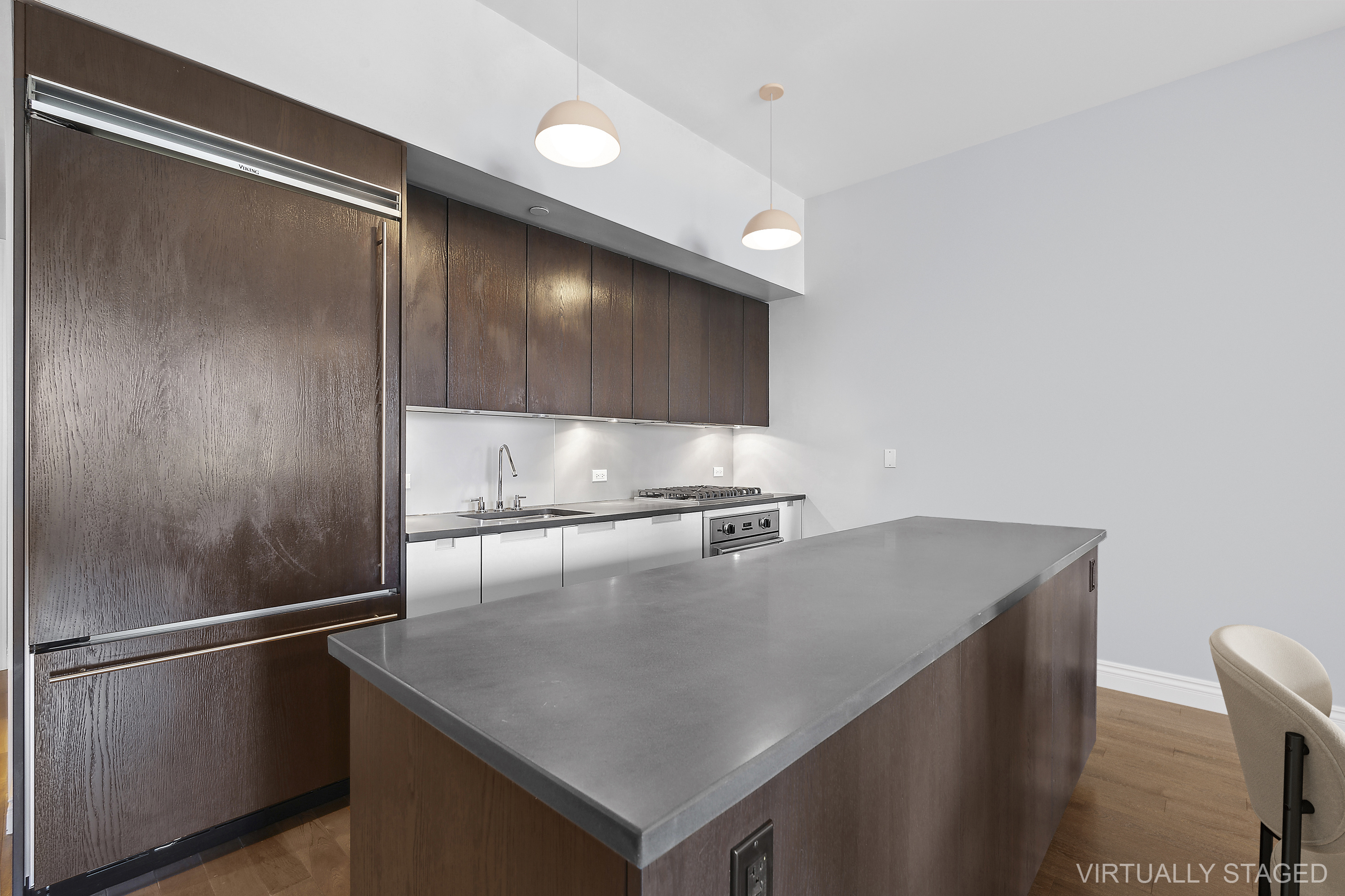 225 5th Avenue, Unit 7K Manhattan, NY 10010 - Photo 4 of 14 a kitchen with white cabinets and stainless steel appliances