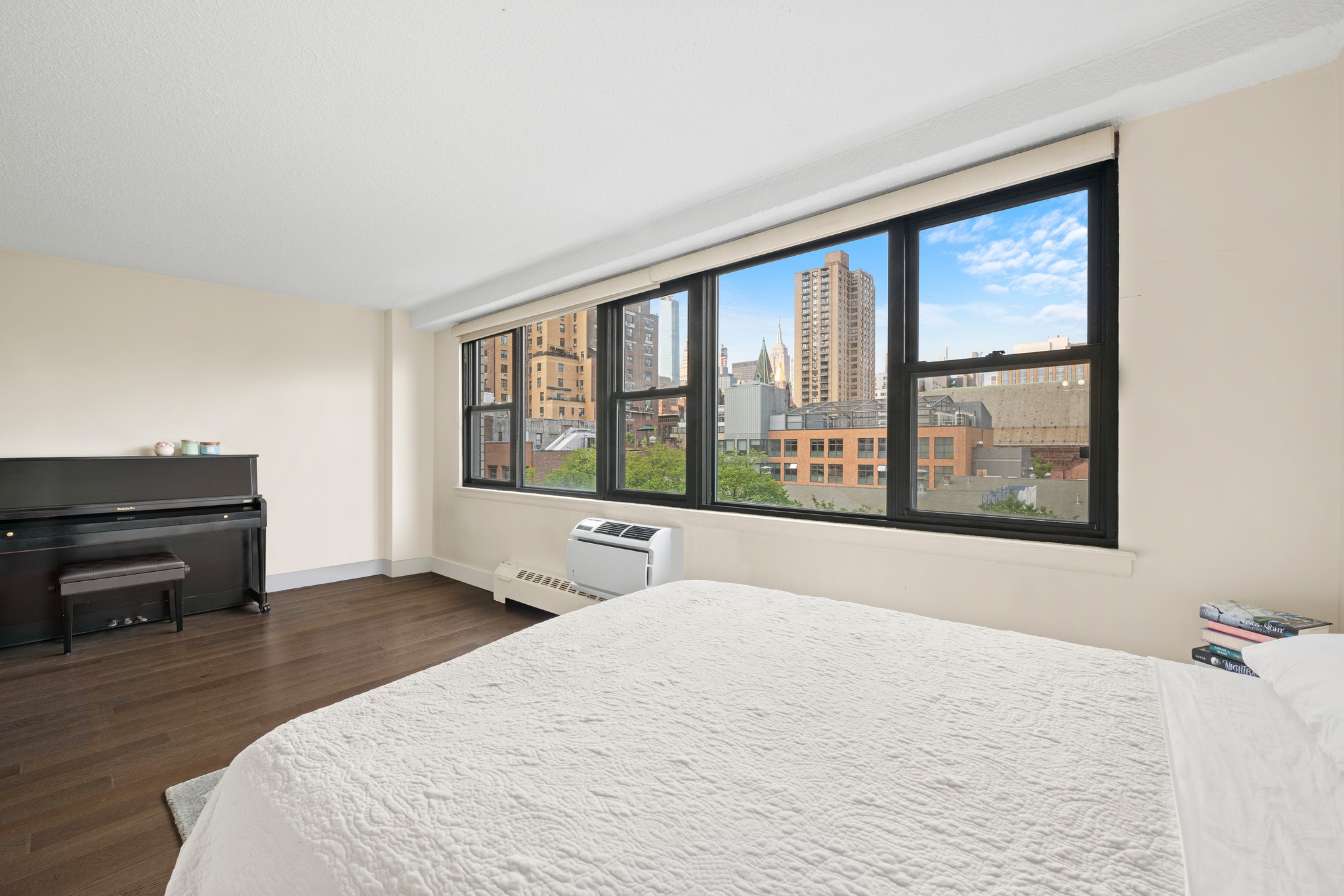 230 East 15th Street, Unit 7P Manhattan, NY 10003 - Photo 3 of 8 a bedroom with a bed and wooden floor