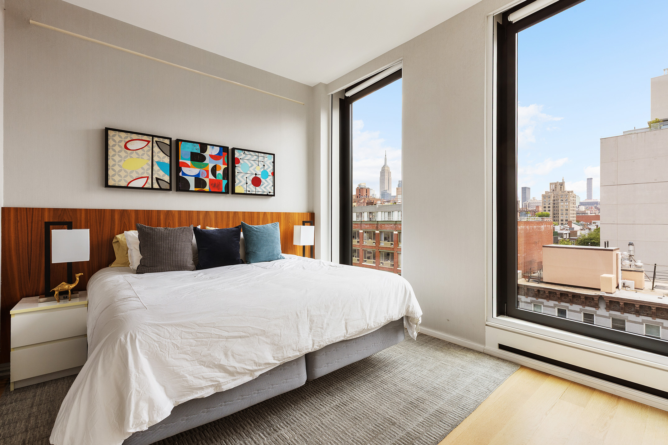 505 West 19th Street, Unit 7B Manhattan, NY 10011 - Photo 11 of 16 a bedroom with a bed and a painting on the wall