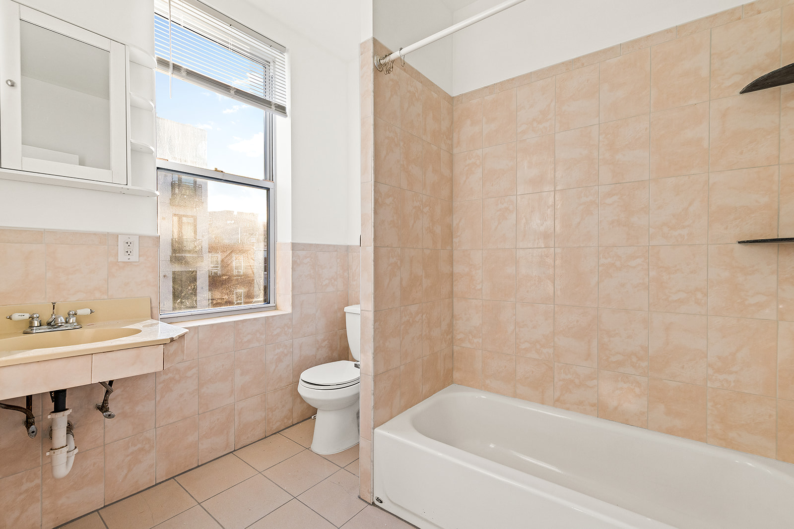 1644 Atlantic Avenue Brooklyn, NY 11213 - Photo 10 of 17 a bath room with a toilet a sink and a bath tub