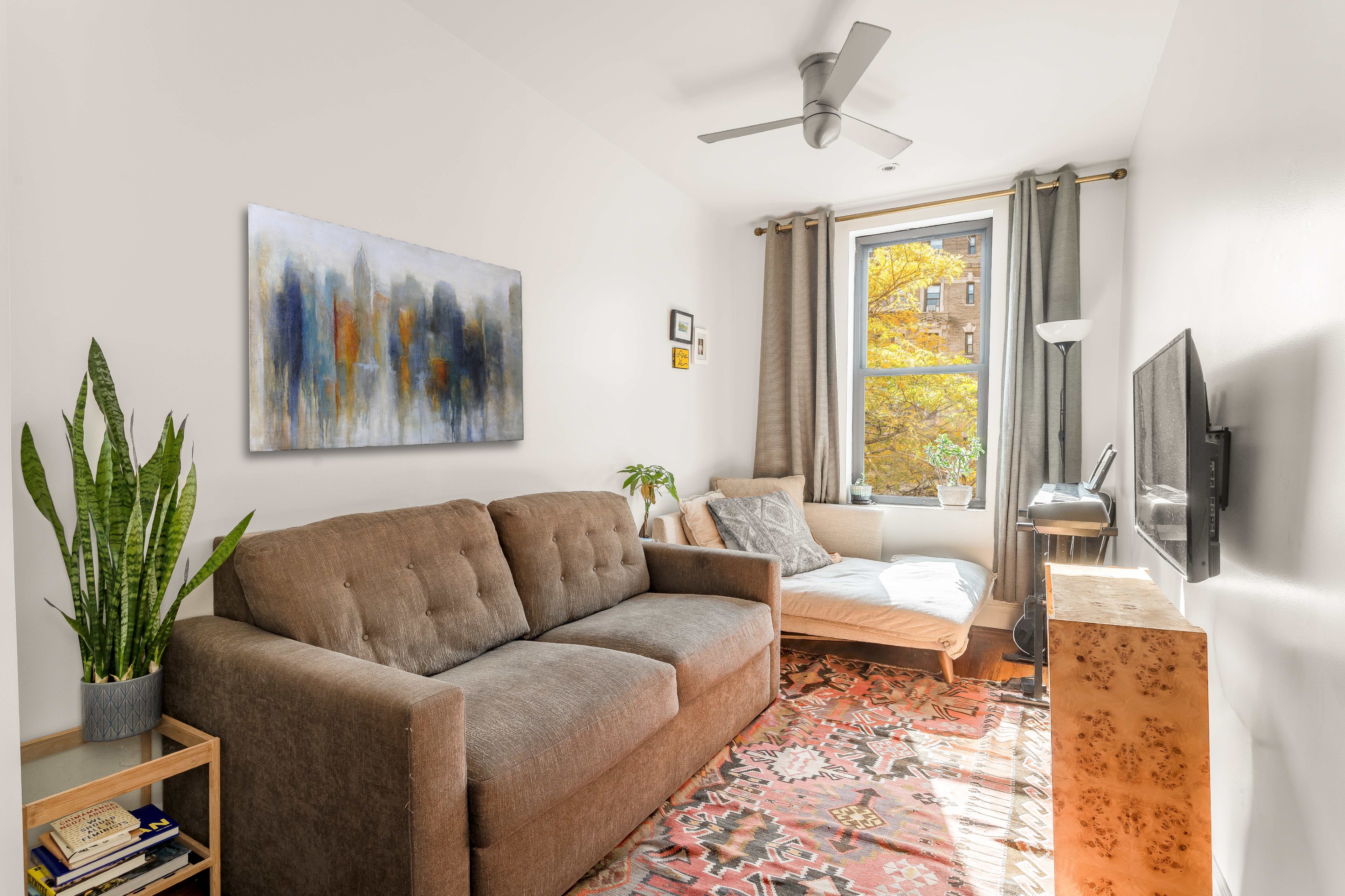 501 West 122nd Street, Unit A2 Manhattan, NY 10027 - Photo 3 of 21 a living room with furniture and a flat screen tv