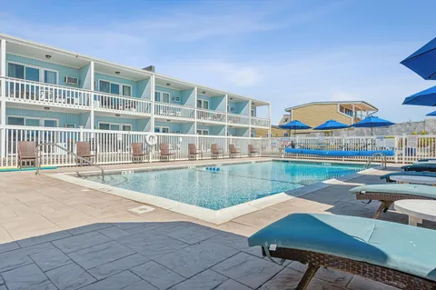 a view of a patio with couches and table under an umbrella