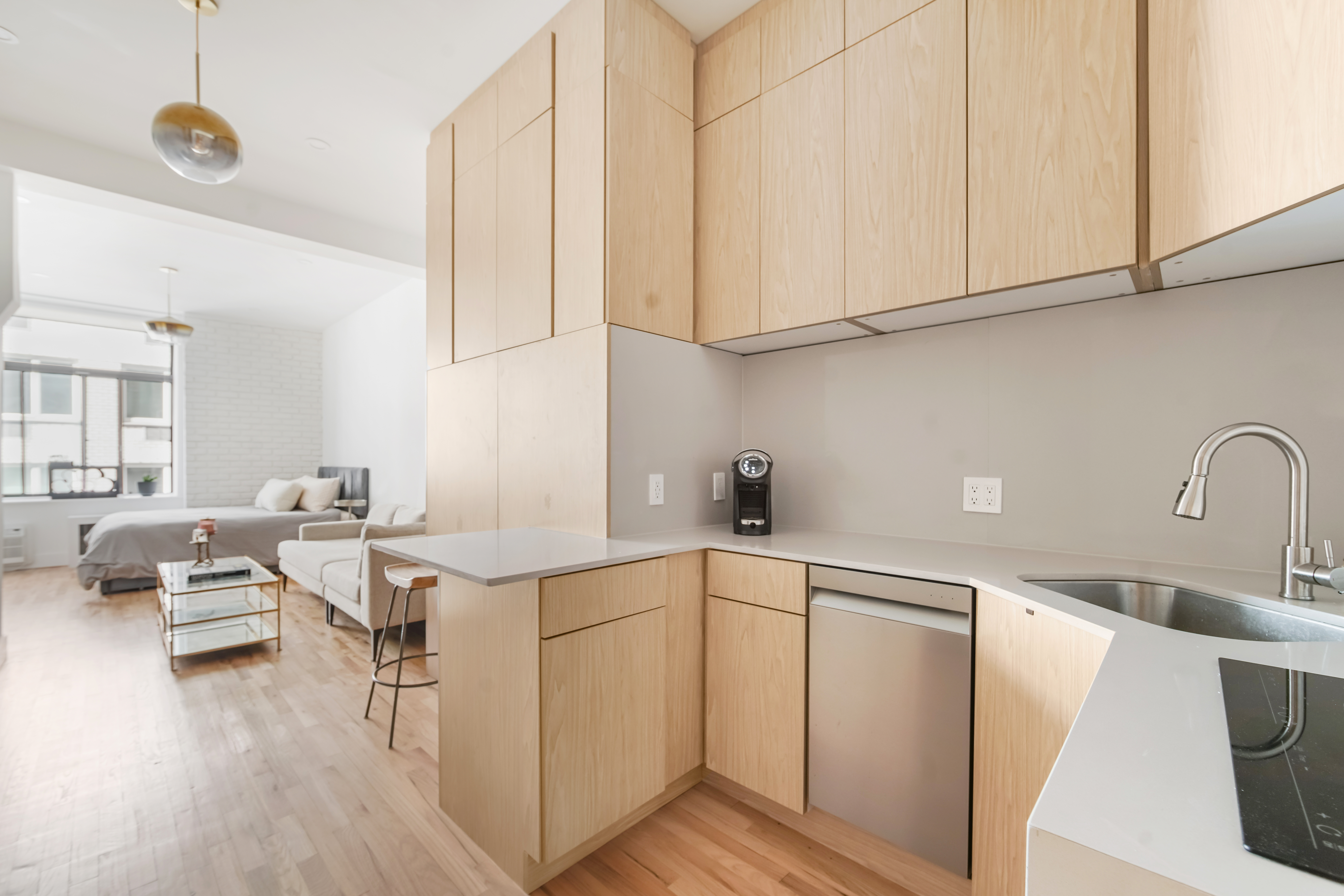 310 East 23rd Street, Unit 3B Manhattan, NY 10010 - Photo 6 of 11 a kitchen with a sink cabinets and appliances