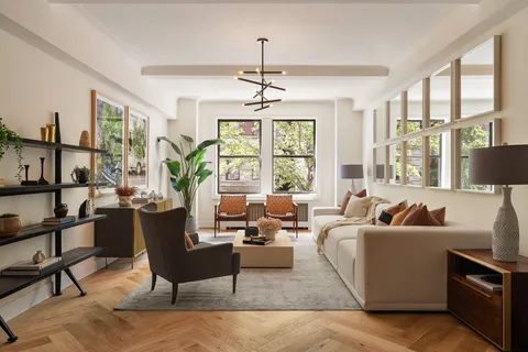 a living room with furniture and floor to ceiling windows