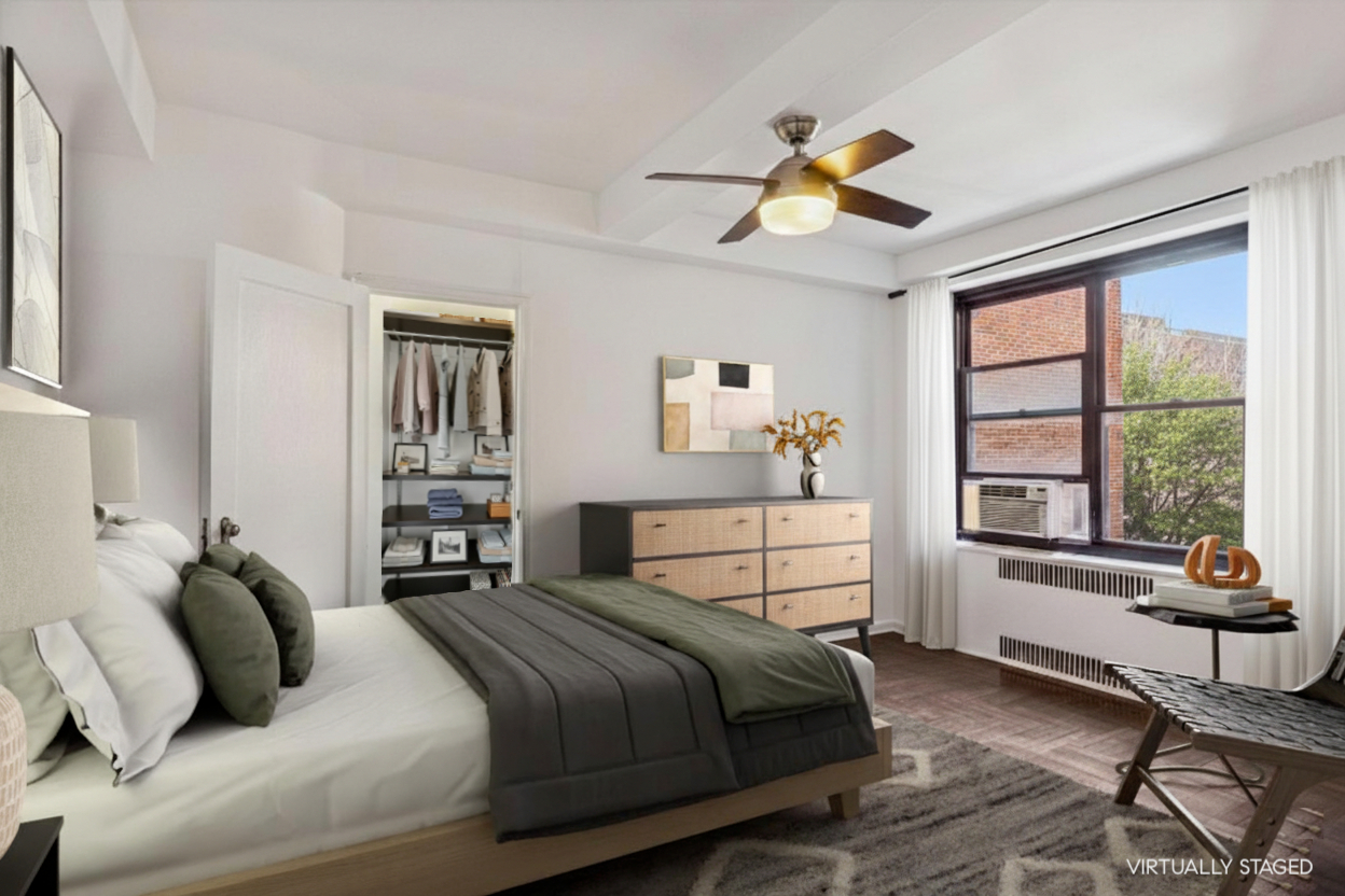 70 Park Terrace West, Unit E74 Manhattan, NY 10034 - Photo 13 of 27 a bedroom with a bed and a window