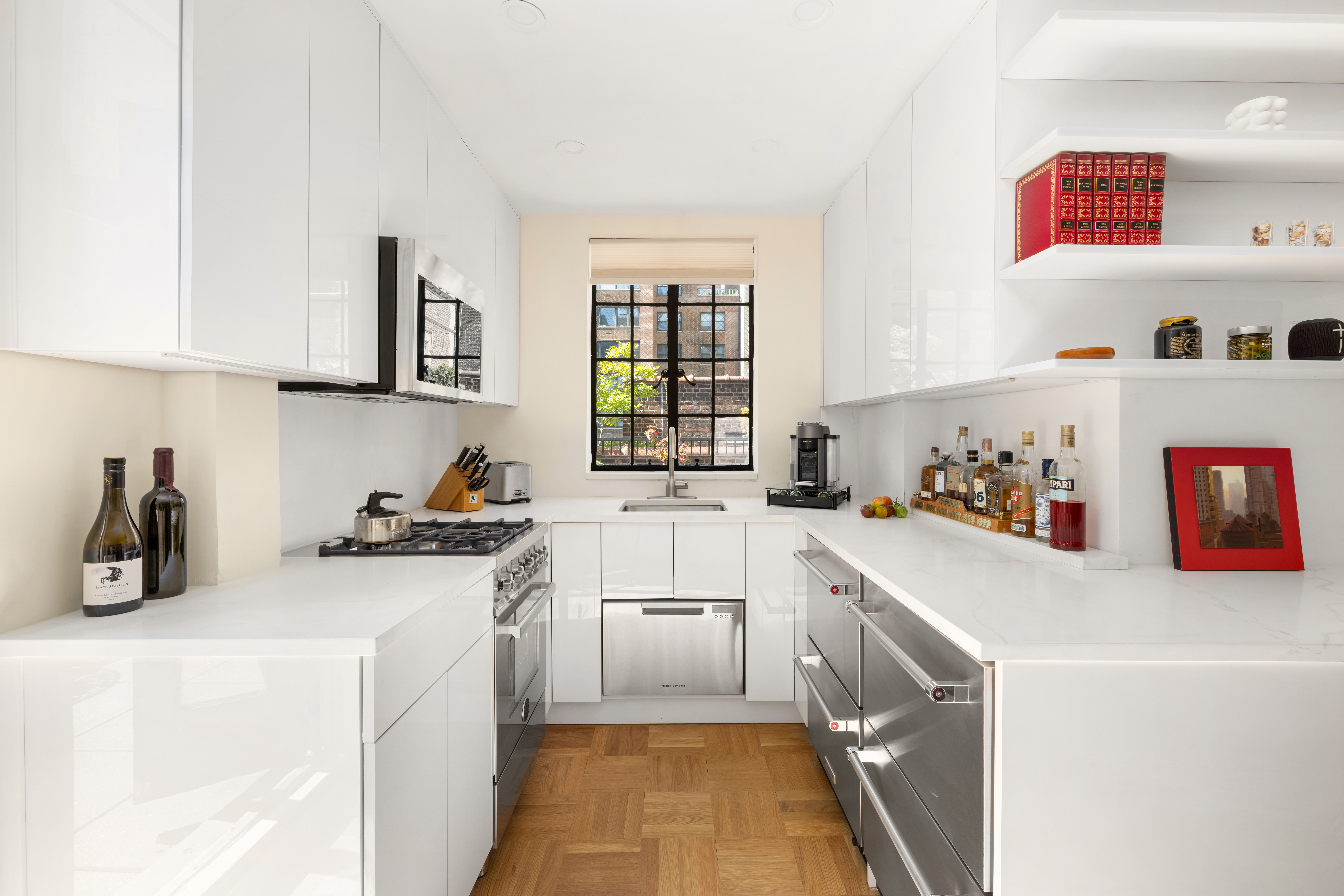 324 East 41st Street, Unit 1103C Manhattan, NY 10017 - Photo 7 of 13 a kitchen with a sink a stove and cabinets