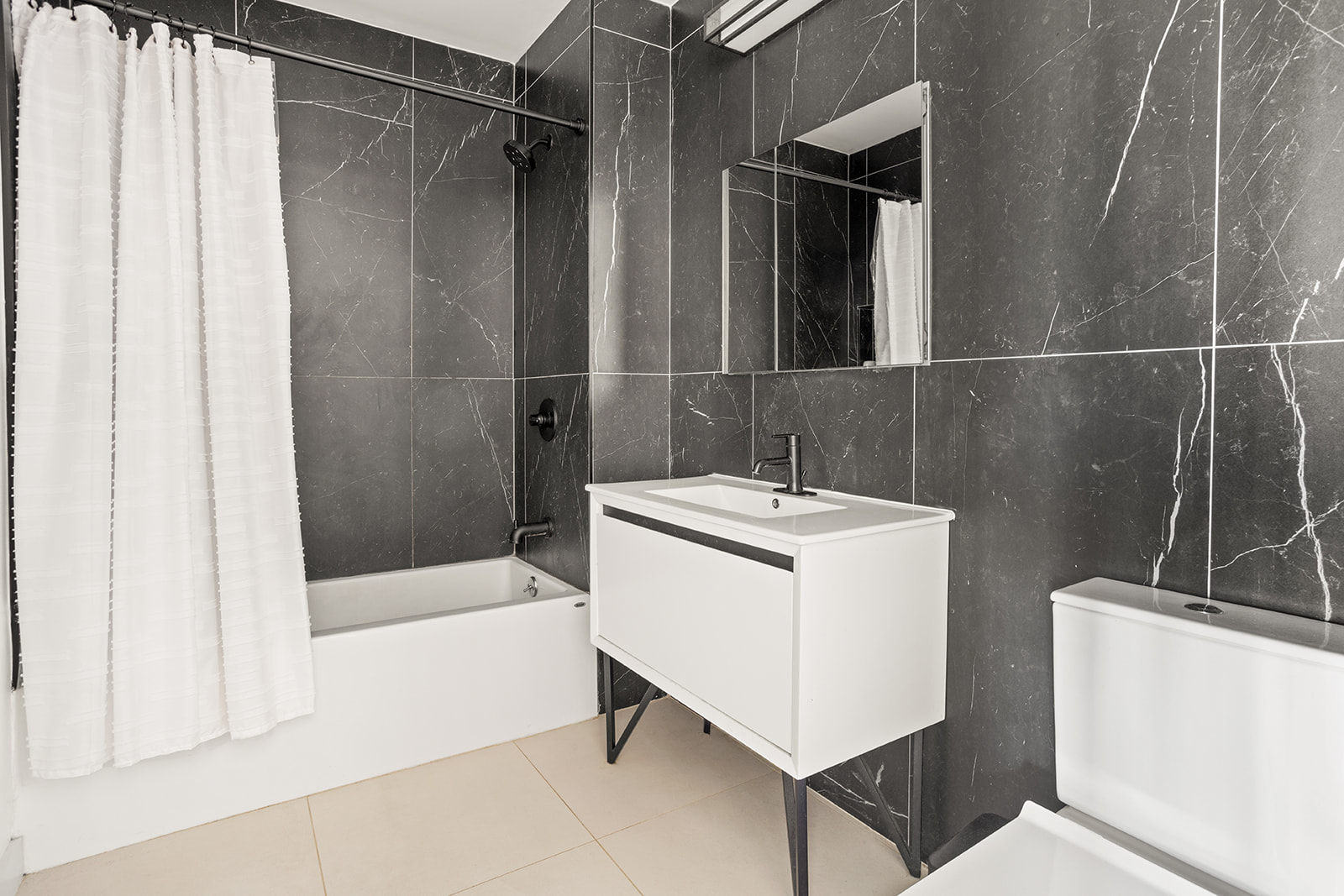 64 Stanhope Street, Unit 2A Brooklyn, NY 11221 - Photo 5 of 9 a bathroom with a sink a toilet and shower