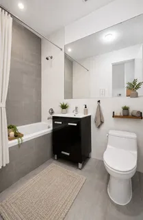a bathroom with a sink a toilet and bathtub